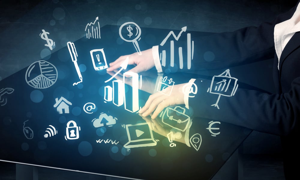 Man touching technology smart table with business icons and symbols